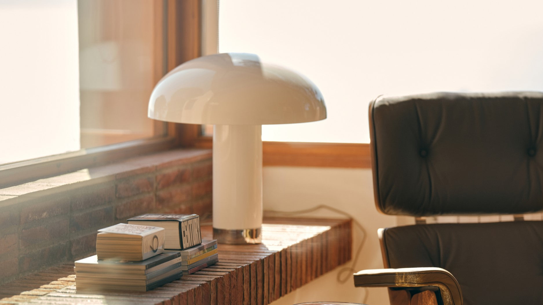 abstract painting, brown daybeds and a bohemian style table lamp
