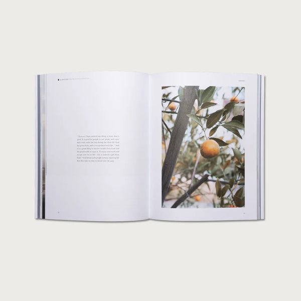 Open book showing a page with a photograph of an orange tree on a white background