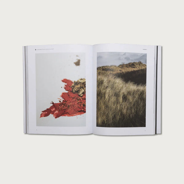 Open book showing two photographs of natural landscapes with red and green colors.