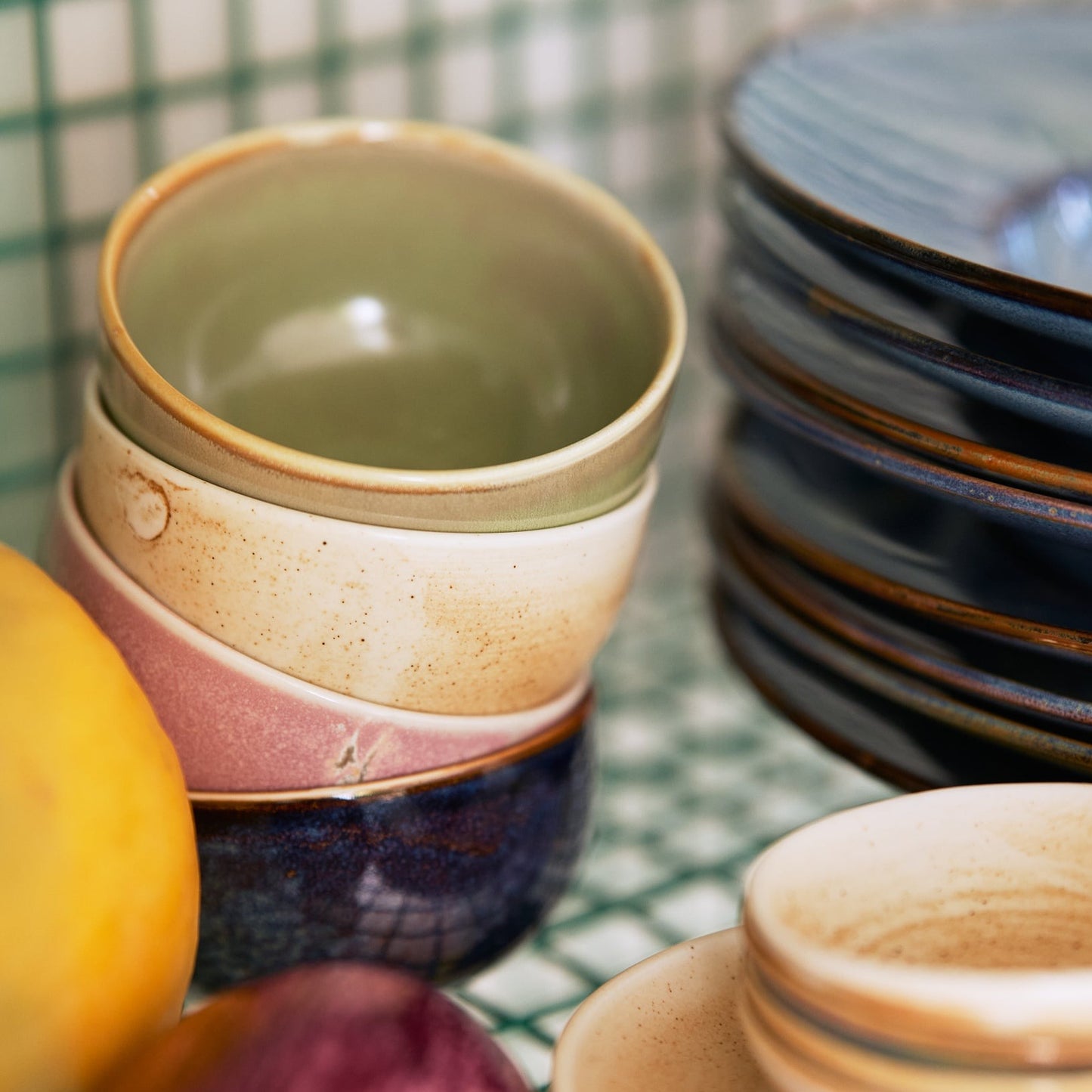 green, cream, pink and blue bowl stacked up