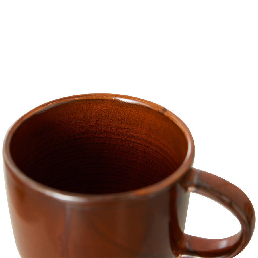 orange brown ceramic mug with ear