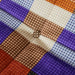 detail of lazy lounge chair with farmhouse orange and purple and black fabric