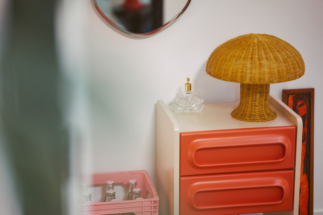 orange and cream retro look nightstand with two drawers with yellow mushroom lamp