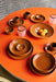 small ceramic bowl orange color on orange table