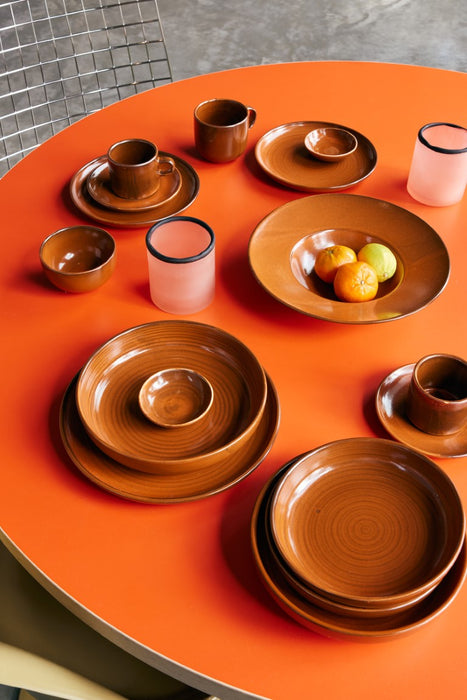 orange table with burned orange chef ceramics with tangerines