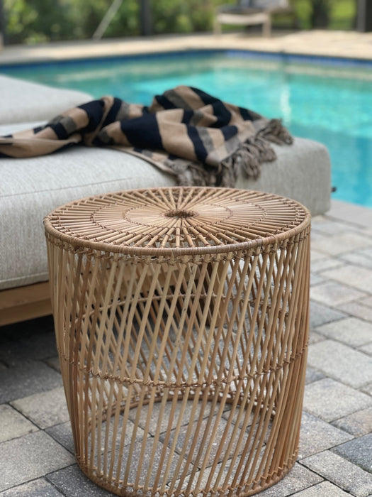 natural wicker side table at pool side
