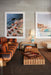 living room with orange and brown striped sofa and framed photo art on wall