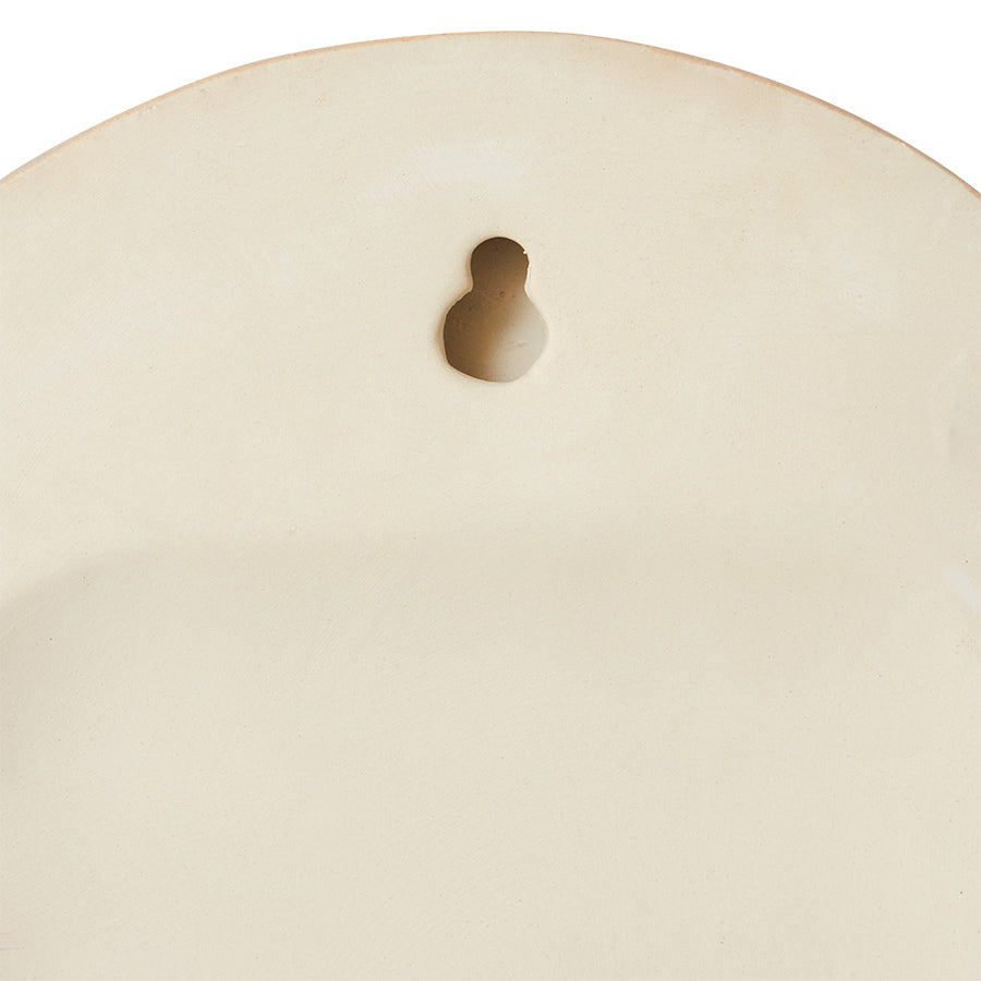 hanging on back of stoneware wall tile