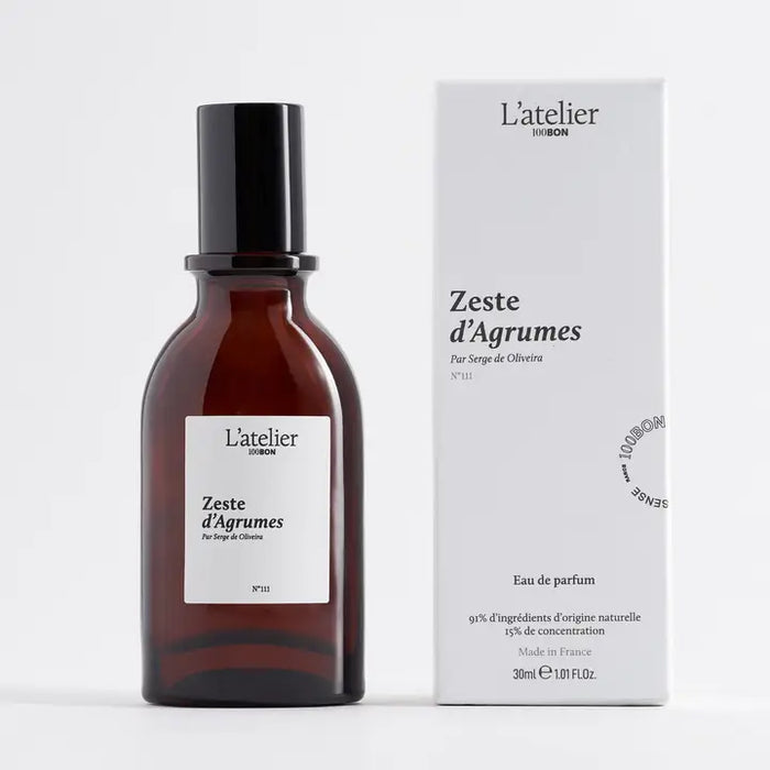 L'atelier Zeste d'Agrumes perfume bottle and packaging on a white background