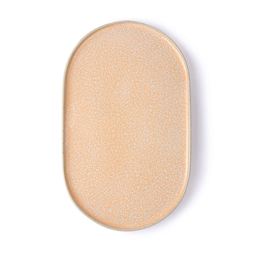 peach colored oval shaped side plate