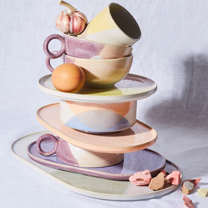 stack of stoneware gallery ceramics in pastel colors