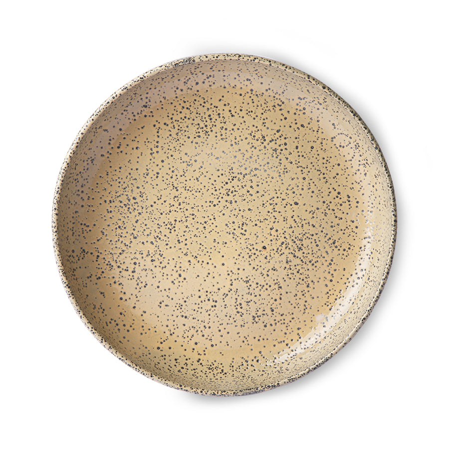 peach colored round deep plate made from speckled stoneware