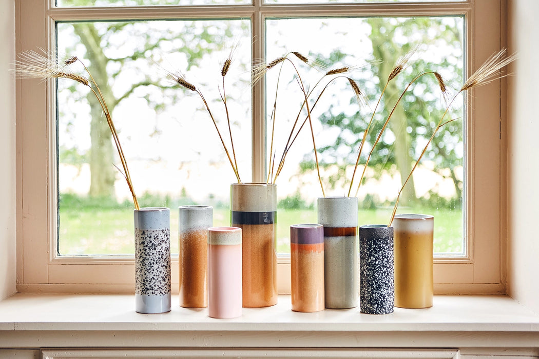 retro style vases in various heights in a window 
