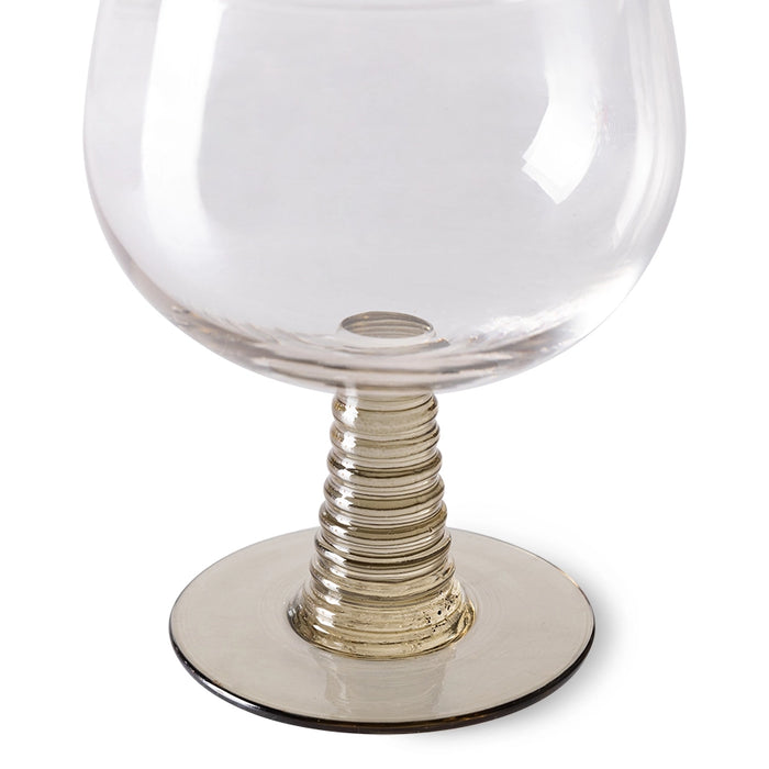 wine glass with a green colored low stem 