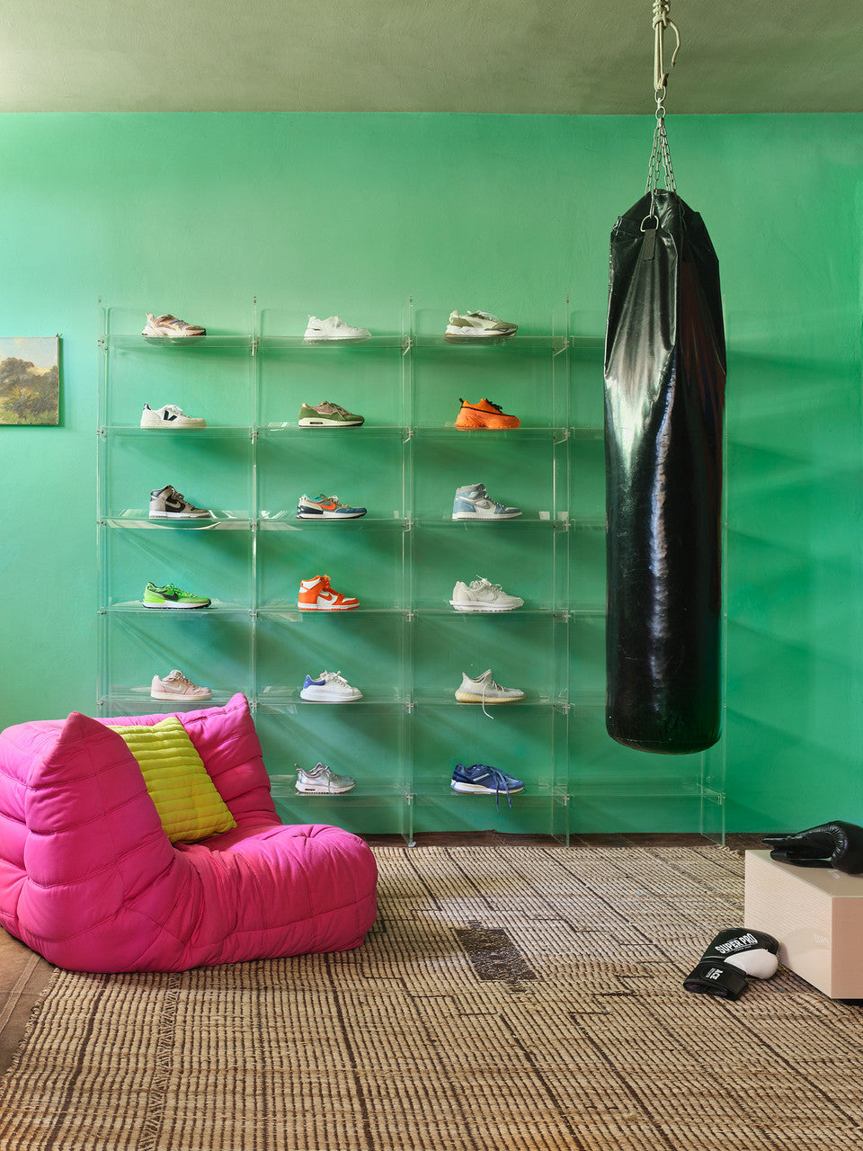 square clay color mirror block table in a room with a green wall, pink chair and boxing gear