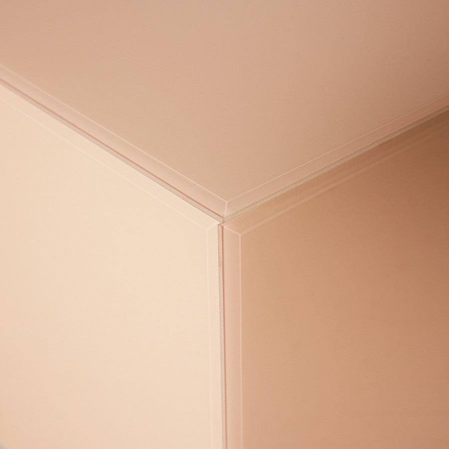 corner of square clay color mirror block table