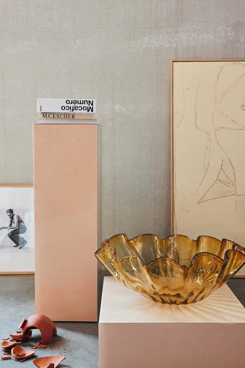 square clay color mirror block table with amber glass bowl and abstract painting