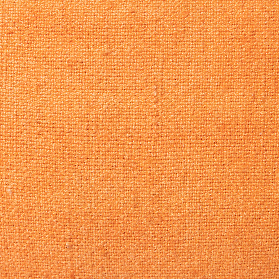 detail of the linen of orange linen lumbar pillow with brown cotton trim