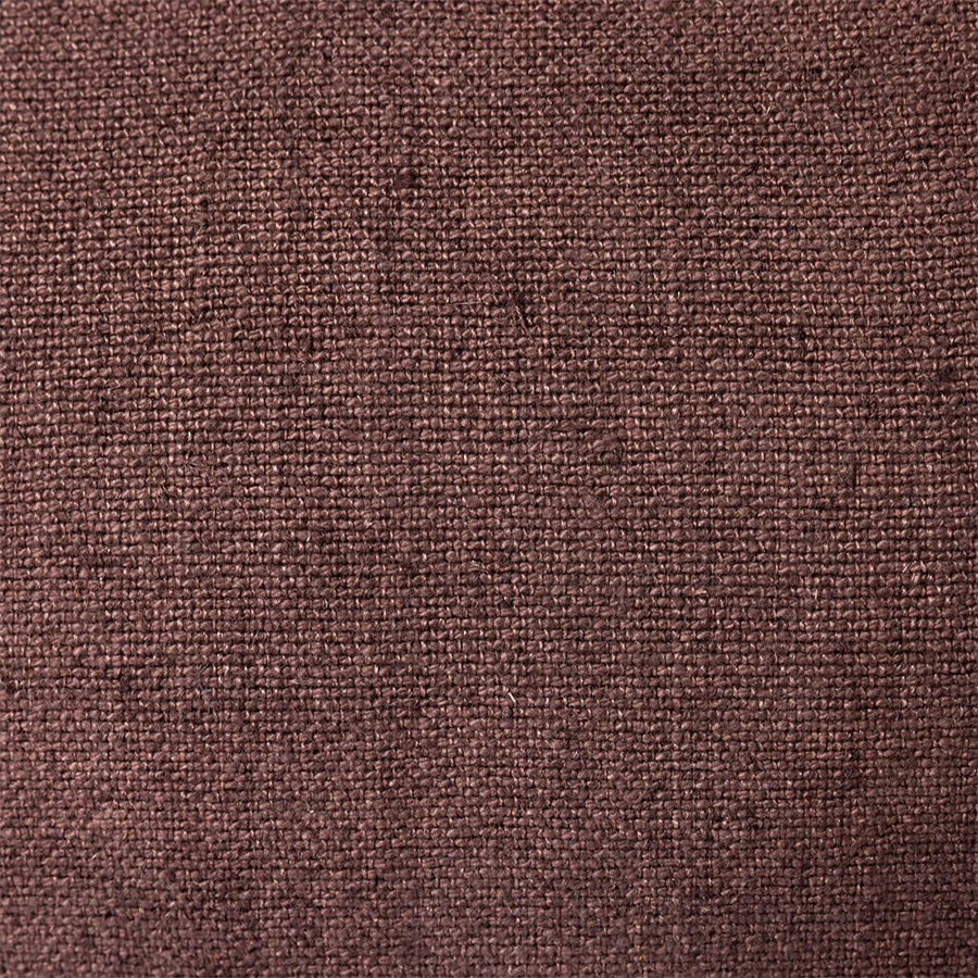 close up of brown linen lumbar pillow with blue cotton trim