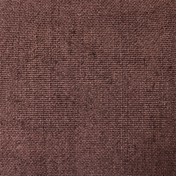 close up of brown linen lumbar pillow with blue cotton trim