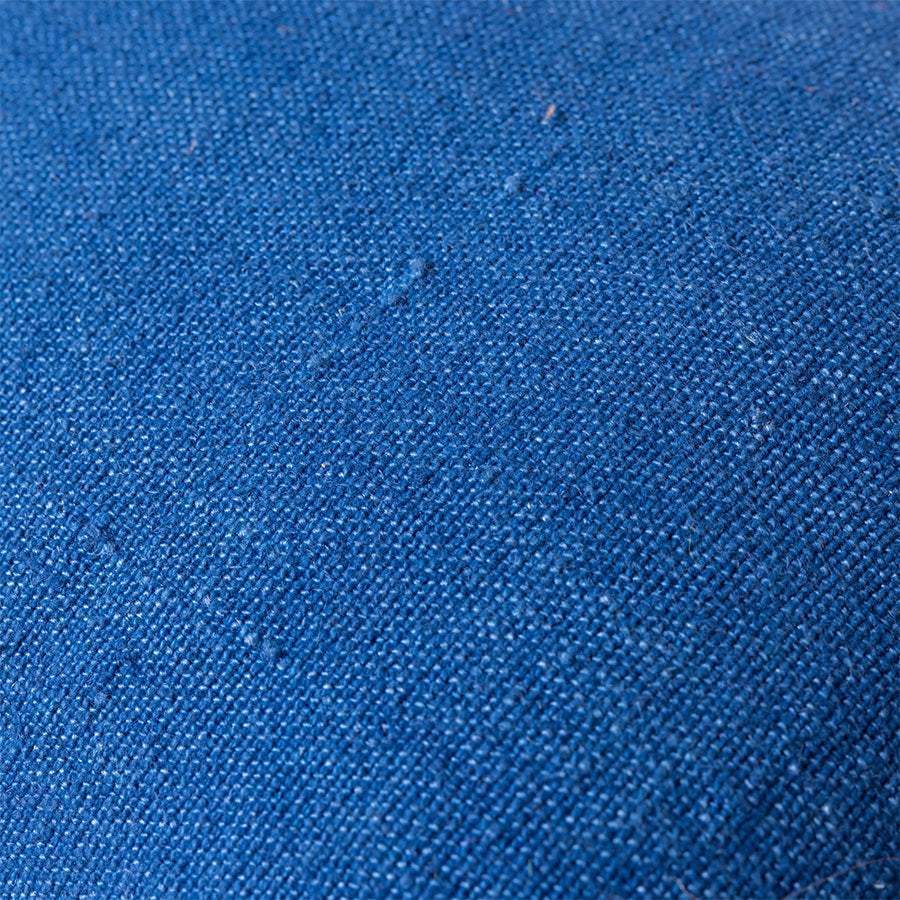 detail of linen from blue linen lumbar pillow with brown cotton trim