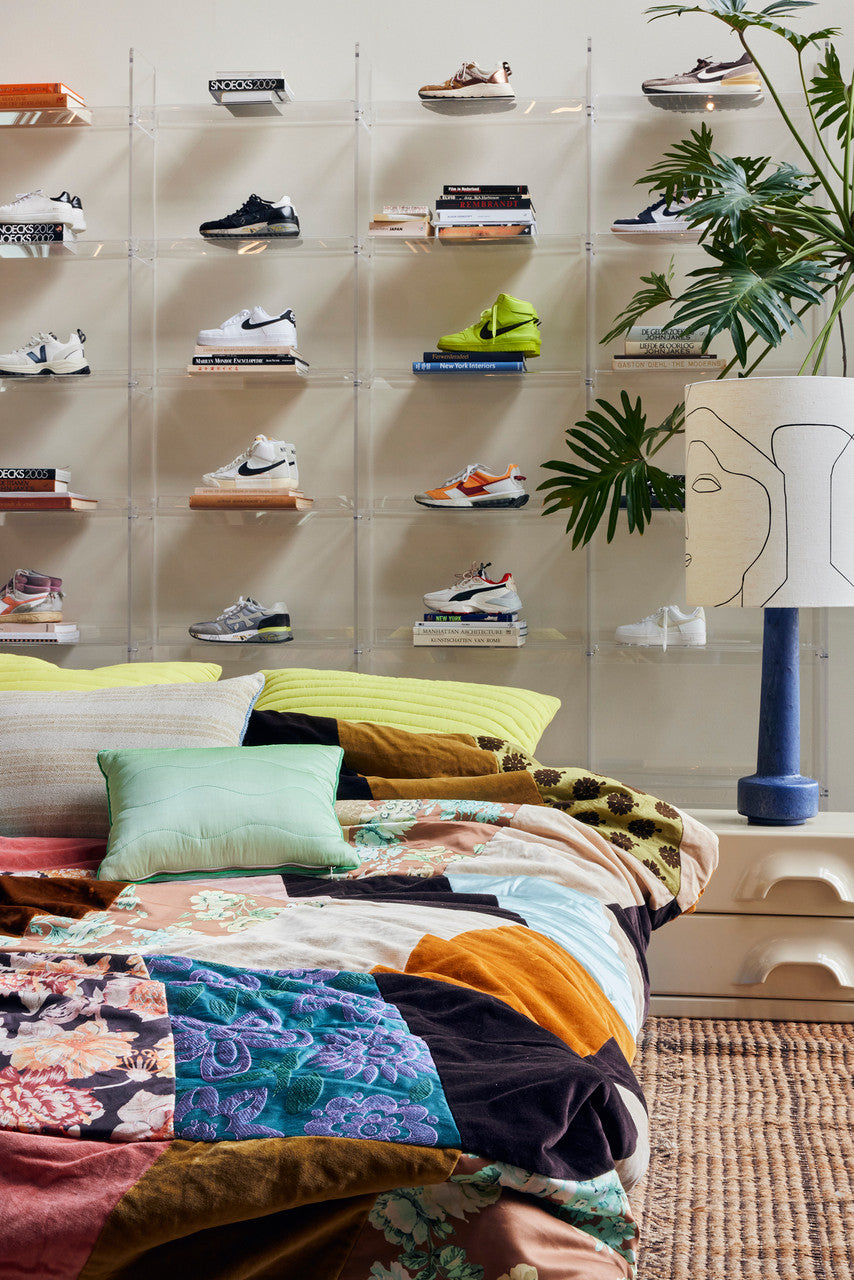 bed with quilt and textured pillows