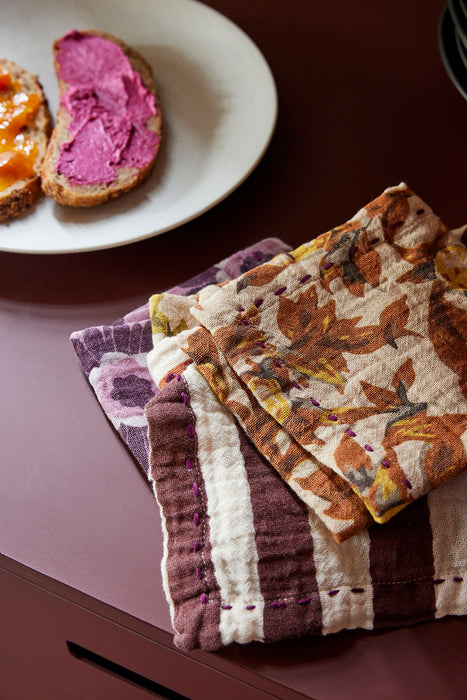 cotton napkins next to a plate with bread