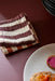 burgundy and white striped cotton napkins on a table