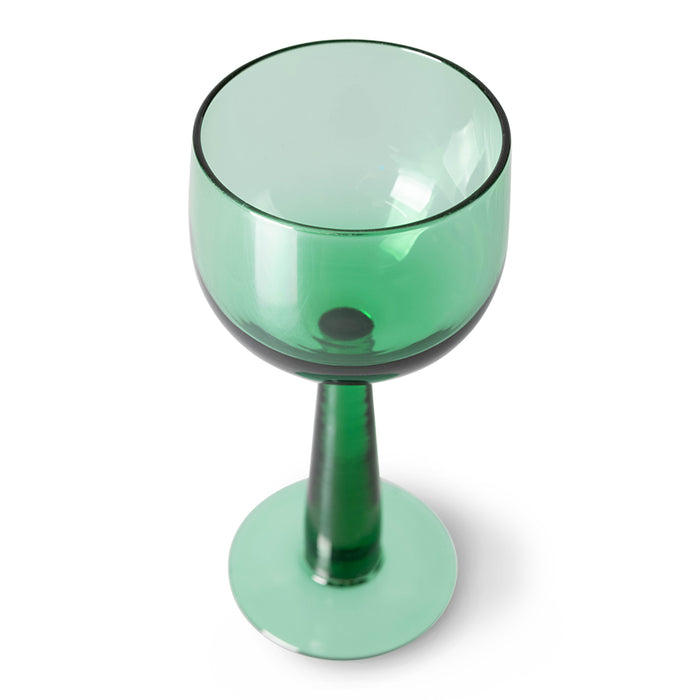 green colored tall stem wine glass