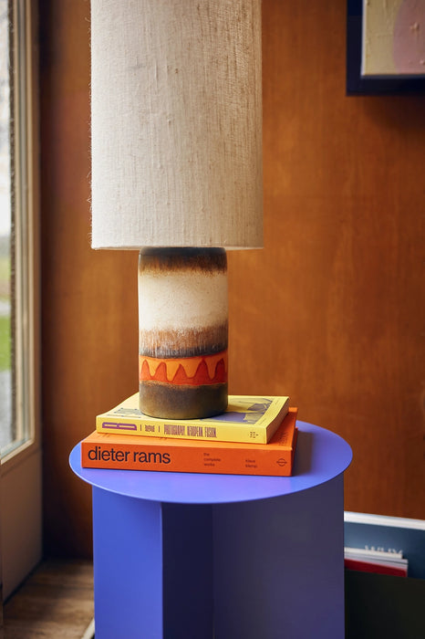 cobalt blue, metal side table with books and a retro style table lamp 