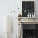 fire place mantel with hand brushed vase and black and white painting in frame