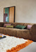 brown corduroy element couch with pink and green lumbar pillows in two sizes