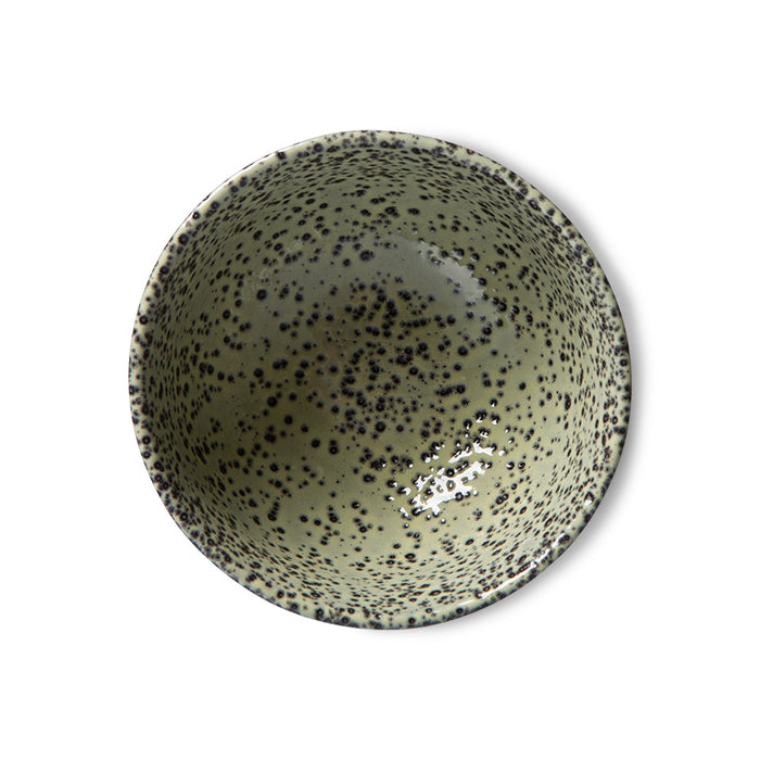 inside of a green speckled ceramic bowl with reactive glaze