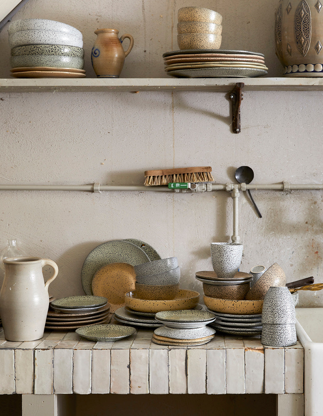 vintage style kitchen with organic shape speckled ceramics in earth colors