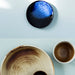 table setting with brown plate, brown bowl and cobalt blue dessert plate
