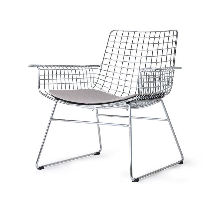 mid century modern style armrest chair in chrome with seat cushion in a light color