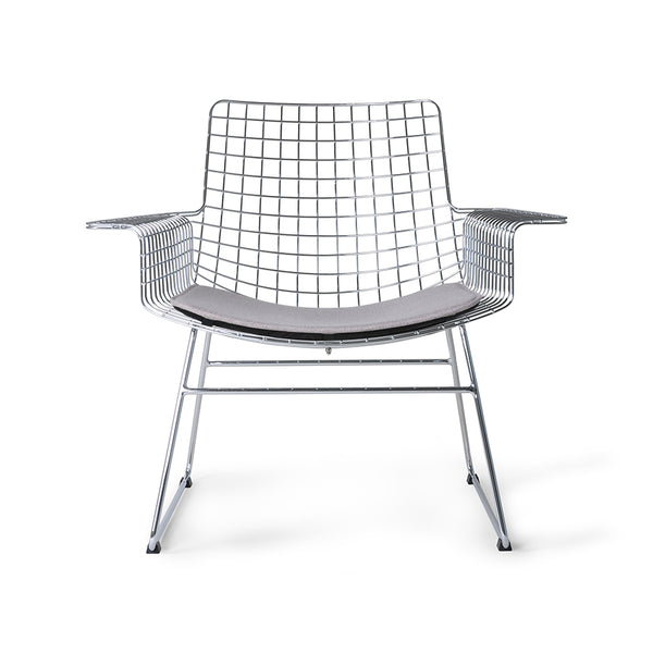 mid century modern style armrest chair in chrome with seat cushion in a light color