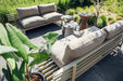 two outdoor sofas with beige seating cushions and an olive green frame