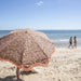 blue sky on Melbourne beach with floweer pattern and fringes retro beach umbrella