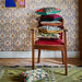 vintage chair with stack of retro inspired pillows