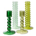 two tall and two lower green glass candle stick holders