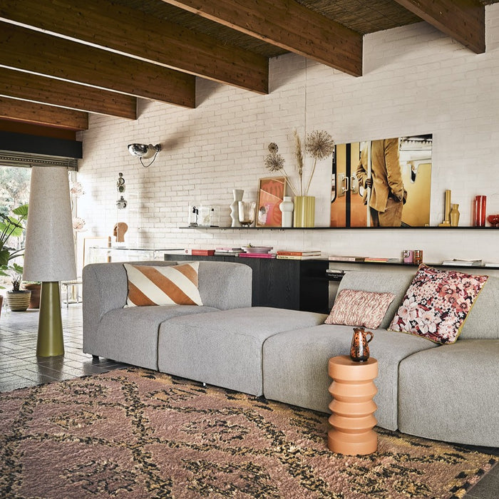 grey sofa with small terracotta side table