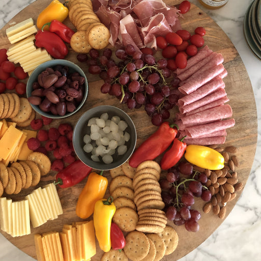 extra large wooden serving board with charcuterie