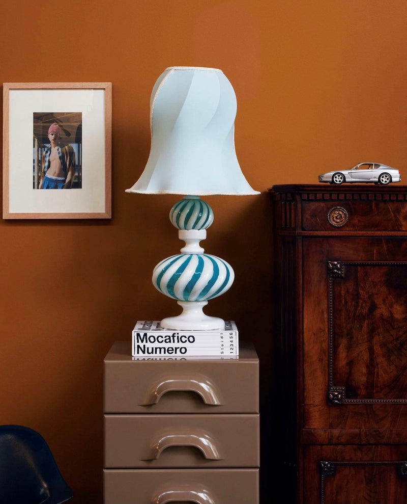 blue and white table lamp glass base and unique shaped shade in antique white with details