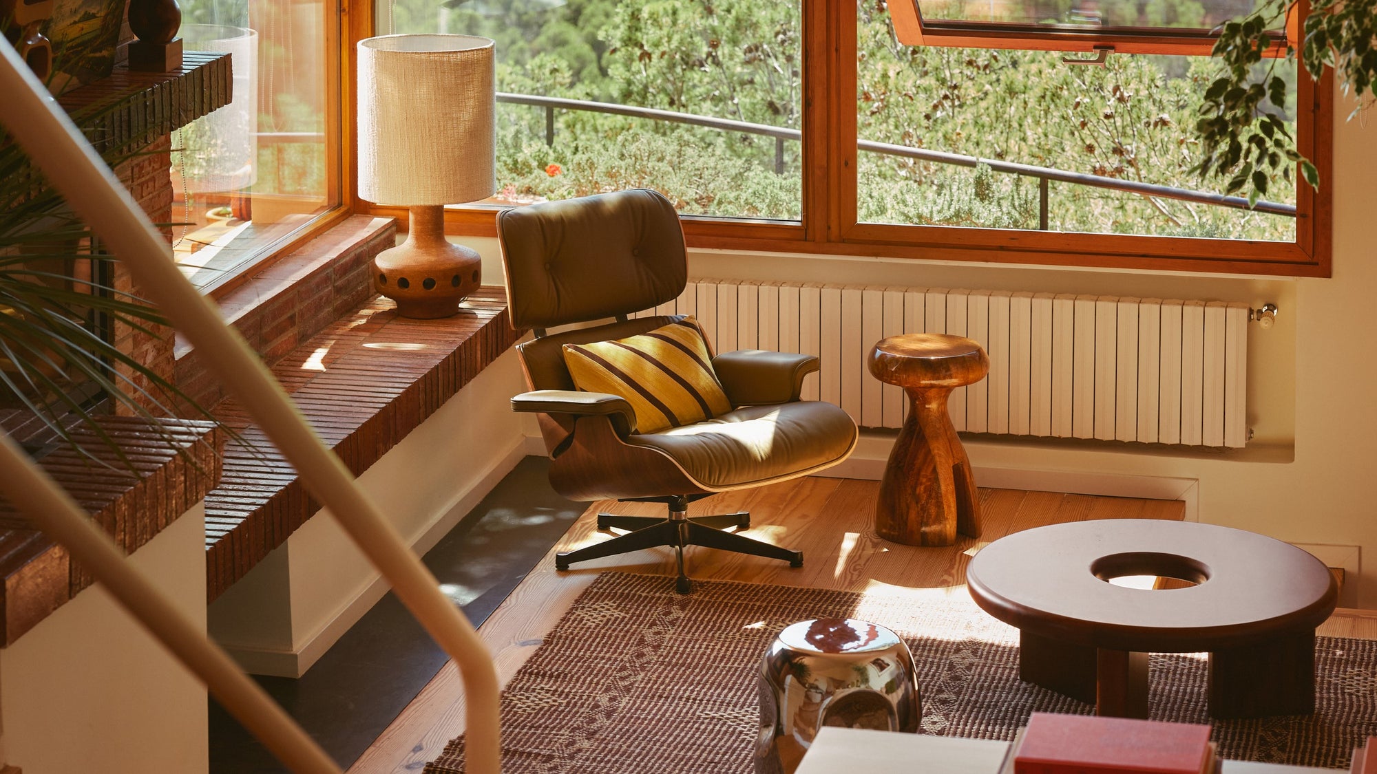 sideboard in pebble color in front of large window, styled with vases and books