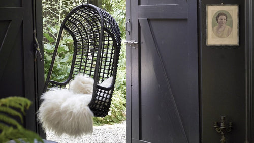 modern farmhouse style with black hanging chair and barndoors