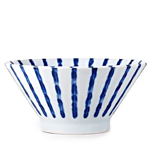 Ceramic bowl with blue and white striped pattern on a white background