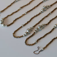 Beaded garland with brown and silver beads on a white background