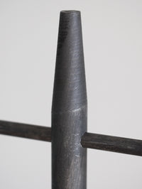 Close-up of a cylindrical metal object on a white background