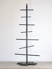 Black metal tree-shaped Christmas tree  on a white background